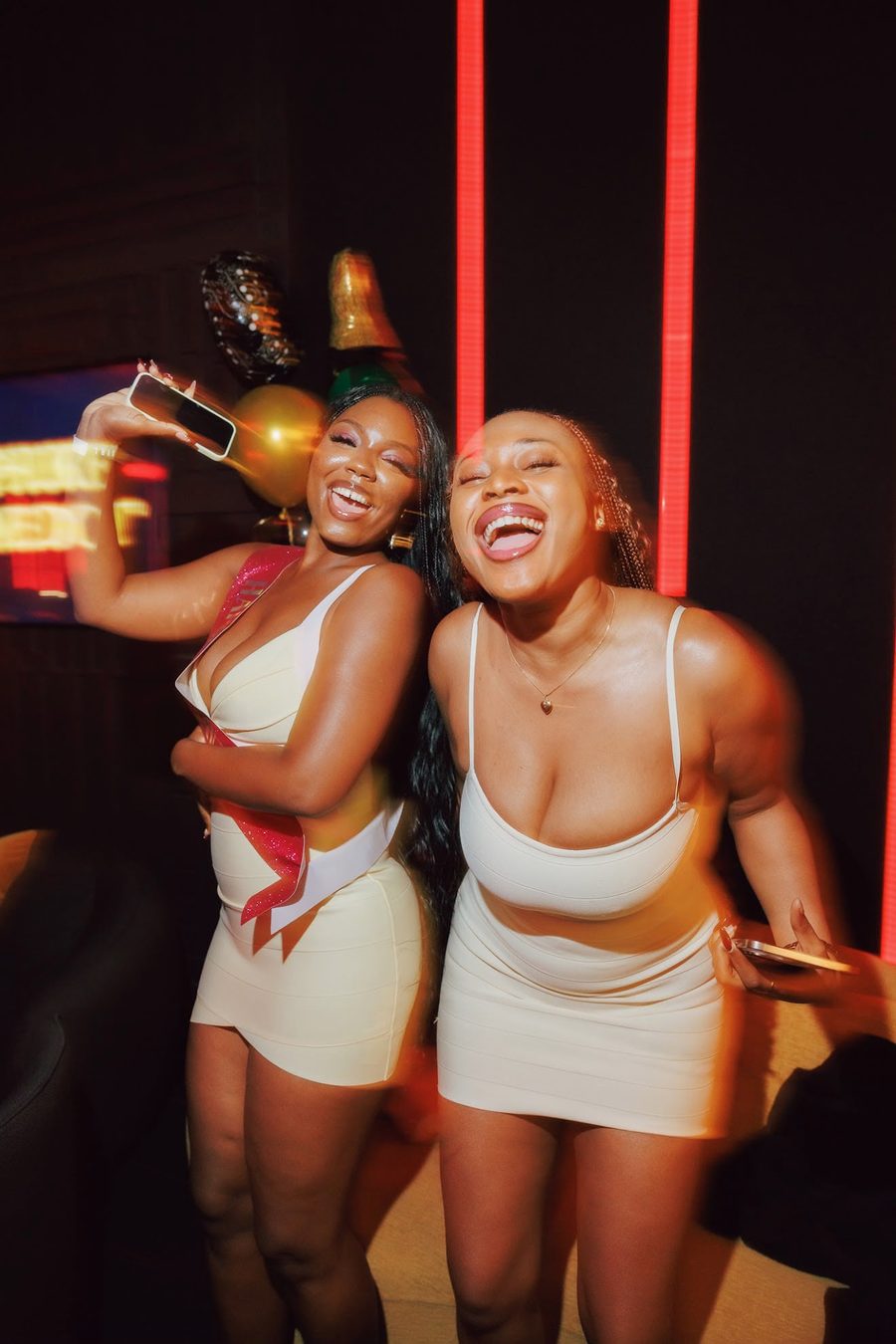 Two guests laughing at an Afro Phuket birthday celebration